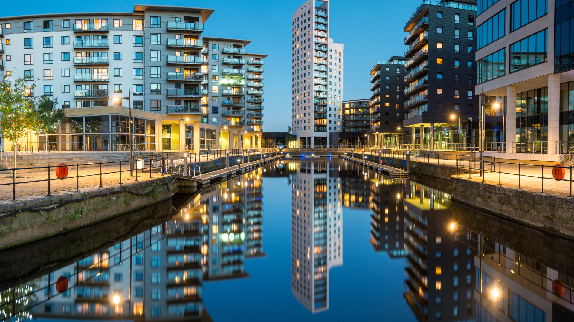 A photo of Leeds Dock in the evening, with the water running towards the residential and office blocks