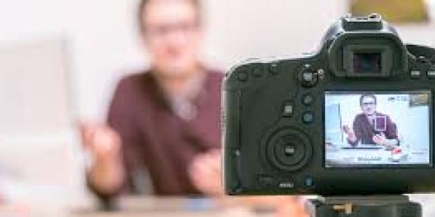 Image of a man been filmed and a camera filming 