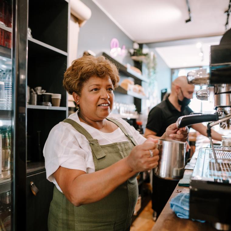 Older woman working barista age positive